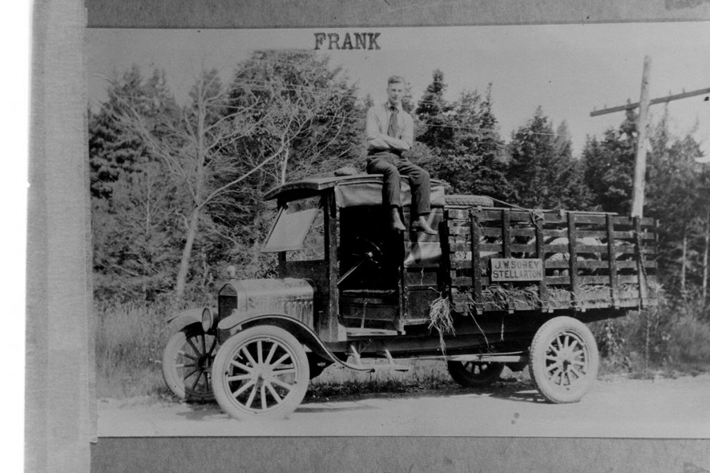 Frank Sobey on top of delivery truck